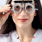 Optometrist examining a patient with a trial frame