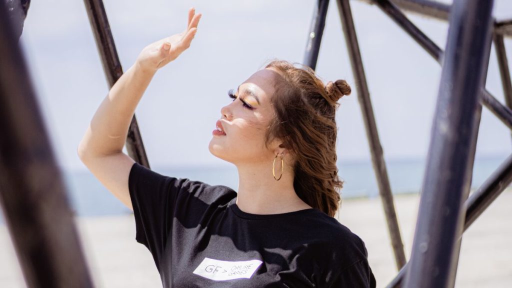 Person shading eyes from bright sunlight