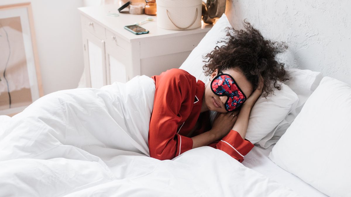Person resting with a warm compress eye mask
