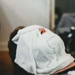 Person relaxing with a warm compress for dry eye